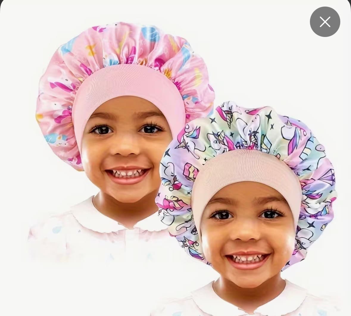 Little girl wearing pink unicorn satin bonnet
